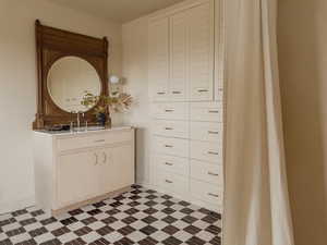 Bathroom with vanity and light flooring