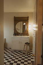 Half bathroom featuring vanity and dark floors