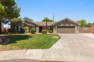 Ranch-style home with stucco siding, concrete driveway, a garage, a tiled roof, and a gate
