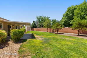 Fenced backyard with a storage shed
