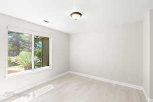 Empty room featuring light wood-style flooring