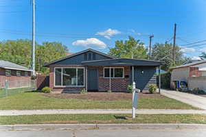 View of front of property with brick siding and a porch