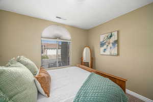 Carpeted bedroom with baseboards