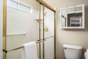 Bathroom with toilet and a shower stall