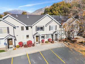 Traditional-style home with uncovered parking and a mountain view