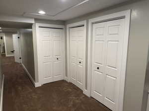 Corridor with colored carpet and recessed lighting