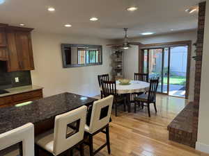 Dining area featuring recessed lighting, light wood-style floors, and healthy amount of natural light