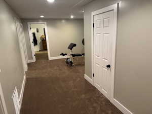 Hall with colored carpet and recessed lighting