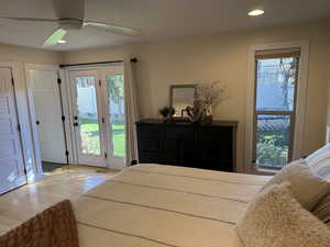 Bedroom with access to outside, multiple windows, recessed lighting, a ceiling fan, and wood finished floors