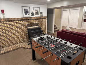 Recreation room with colored carpet and baseboards