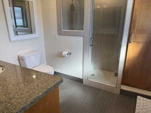 Bathroom featuring vanity and a shower stall
