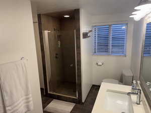 Bathroom featuring a shower stall, vanity, and tile patterned floors
