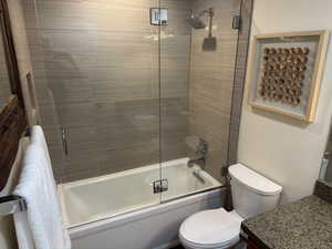 Bathroom featuring enclosed tub / shower combo and vanity