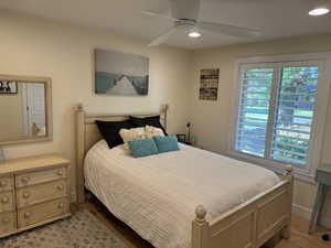 Bedroom featuring recessed lighting, a ceiling fan, and light wood-style flooring