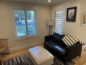 Living area featuring light wood finished floors and recessed lighting