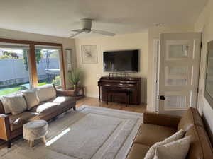 Living room with wood finished floors and a ceiling fan