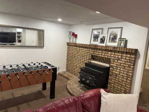 Game room featuring dark carpet, a textured ceiling, and recessed lighting
