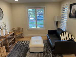 Sitting room with wood finished floors and recessed lighting