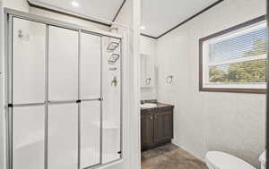 Full bathroom with vanity, a stall shower, and crown molding