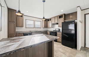 Kitchen featuring black appliances, pendant lighting, dark stone counters, under cabinet range hood, and recessed lighting