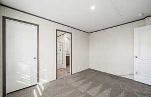 bedroom with carpet floors, ornamental molding, connected bathroom, and recessed lighting