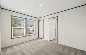 bedroom with carpet, ornamental molding, recessed lighting, and a closet