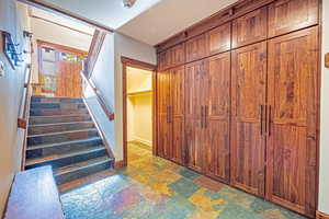 Stairs featuring stone tile floors