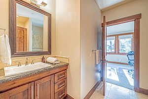 Full bath featuring vanity and light tile patterned floors