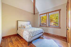 Bedroom featuring wood finished floors and baseboards