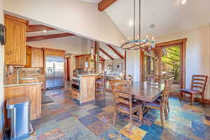 Dining room featuring recessed lighting, a chandelier, and stone tile floors