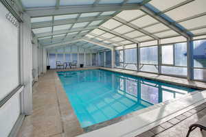 Indoor pool featuring a sunroom