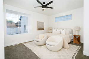 Bedroom featuring a ceiling fan and carpet