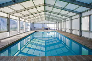 Indoor pool featuring a sunroom