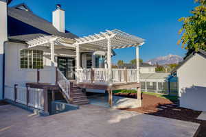 Wooden terrace with a mountain view, a pergola, and a patio area