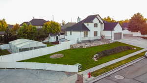 View of front of property with a fenced backyard, stucco siding, a chimney, and concrete driveway