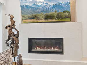 Fireplace accented with gorgeous wood artwork.