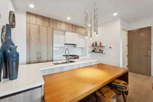 Eat in kitchen bar and exquisite light fixture. The perfect space for a quick bite before or after hitting the slopes.