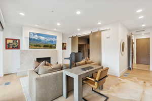Media room with barn door entry into the bunk room.