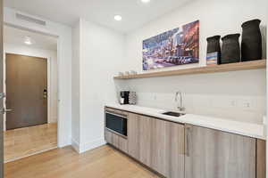 Condo level one foyer/laundry; level one lockout; view of wet bar.