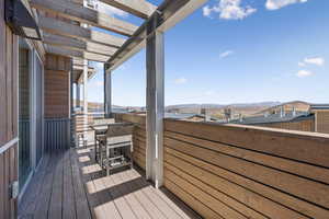 Wooden terrace featuring a mountain view