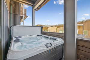 Bottom level deck featuring a private hot tub.