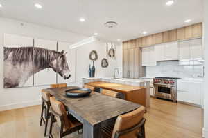 Dining space highlighted with modern light fixtures and magnificent artwork.