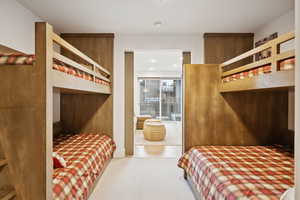 Bunk room with view into the media room.