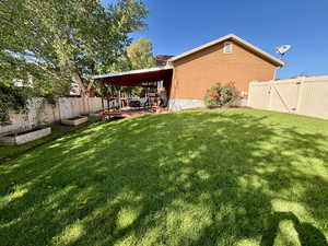 Fenced backyard with a gate and a wooden deck