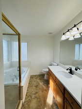 Master full bathroom featuring vanity, a garden tub, and a stall shower