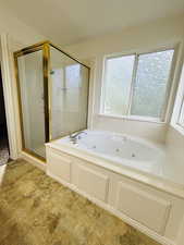 Master full bath with a jetted tub and a stall shower