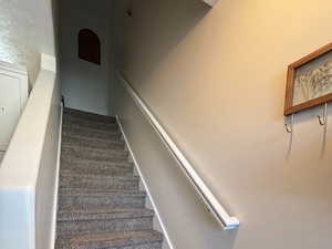Staircase featuring baseboards and wood finished floors