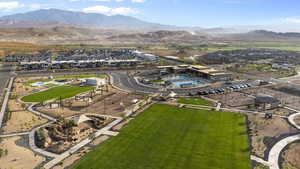 Aerial view of residential area with a pool and a mountain backdrop