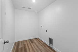 Laundry room with wood finished floors, hookup for an electric dryer, and hookup for a washing machine