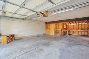 Garage featuring wood walls and a garage door opener
